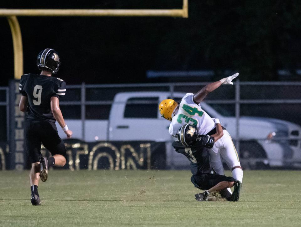 Jeremiah Shelby (34) is finally brought down by Trelin Carnegia (3) during the Pensacola Catholic vs Milton football game at Milton High School on Thursday, Sept. 1, 2022.