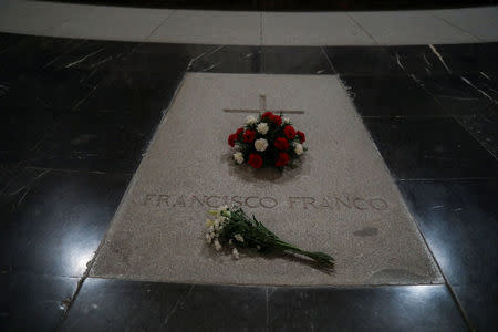 Flowers lie on the tomb of Spanish dictator Francisco Franco at El Valle de los Caidos (The Valley of the Fallen), the giant mausoleum holding the remains of Franco, in San Lorenzo de El Escorial, outside Madrid, Spain, June 19, 2018. REUTERS/Susana Vera