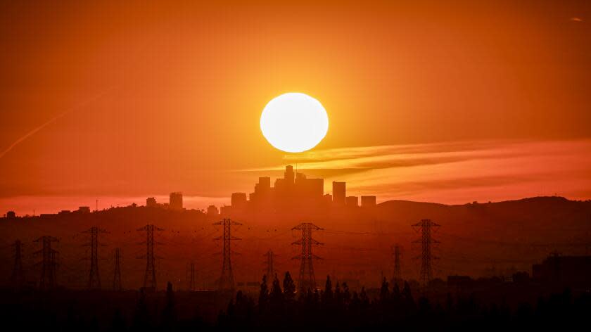 Azusa, CA, Friday, February 9, 2024 - The sun sets behind the LA skyline as seen from Azusa. (Robert Gauthier/Los Angeles Times)