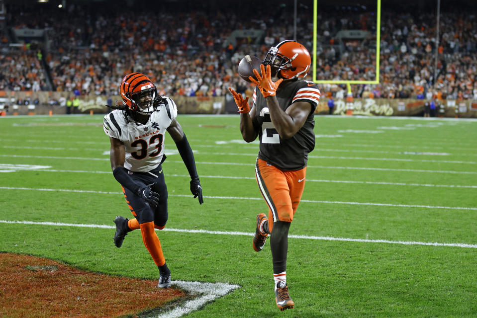 Cleveland Browns wide receiver Amari Cooper (2) catches a pass from quarterback Jacoby Brissett for a touchdown with Cincinnati Bengals cornerback Tre Flowers (33) defending during the second half of an NFL football game in Cleveland, Monday, Oct. 31, 2022. (AP Photo/Ron Schwane)