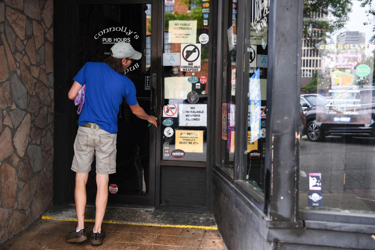 Johnnie Connelly, manager at Connolly's, enters the bar ahead of his shift in downtown Greenville on Friday, May 3, 2024.