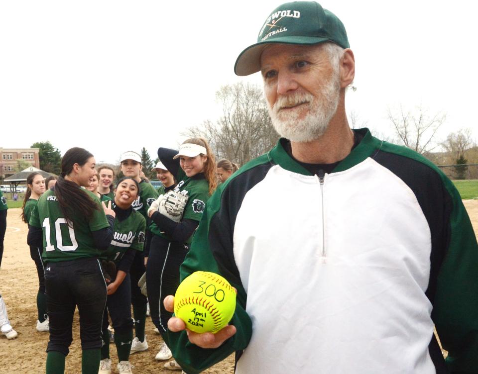 Griswold coach Rick Arremony gets a ball with the number 300 on it from Griswold Athletic Director Stephen Cravinho during his 300th win Wednesday in Griswold.