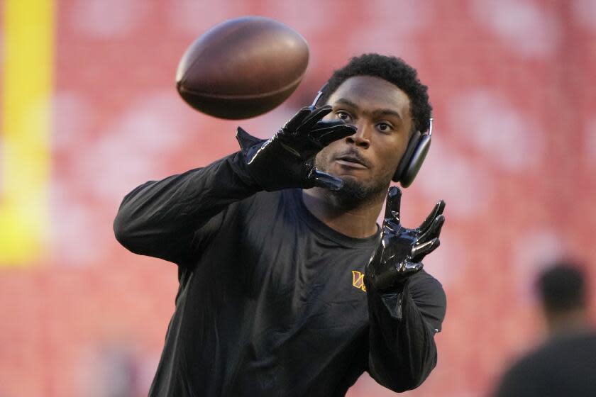 Washington Commanders safety Kamren Curl warms up before a game against the Chicago Bears.