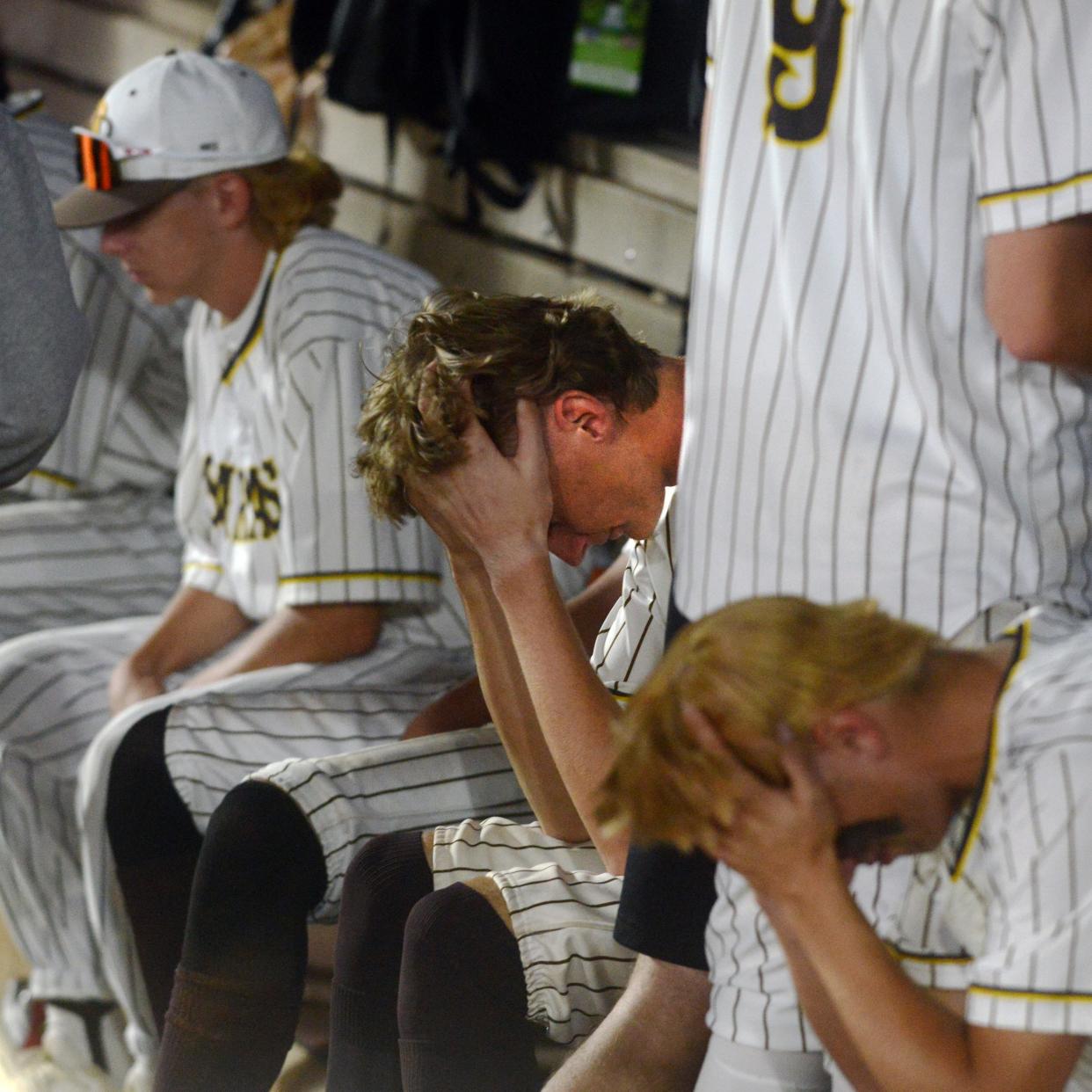 Roger Bacon players sit on the bench following a 3-0 loss to Milan Edison in a Division III state semifinal at Akron's Canal Park. The game was scoreless before the Chargers scored three times in the eighth to earn the victory.