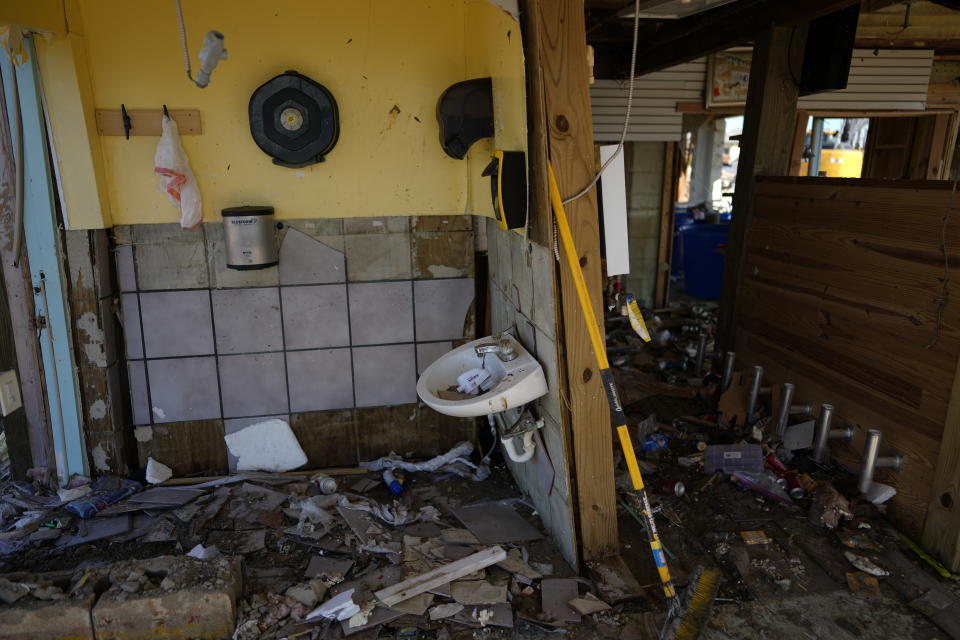 A bathroom lies exposed and missing fixtures at Getaway Marina, as owner Robert Leisure begins the long process of rebuilding his business after the passage of Hurricane Ian, on San Carlos Boulevard in Fort Myers Beach, Fla., Sunday, Oct. 2, 2022. (AP Photo/Rebecca Blackwell)