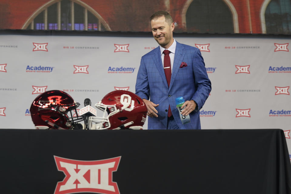 Oklahoma head football coach Lincoln Riley smiles as he heads to sit during NCAA college football Big 12 media days Wednesday, July 14, 2021, in Arlington, Texas. (AP Photo/LM Otero)