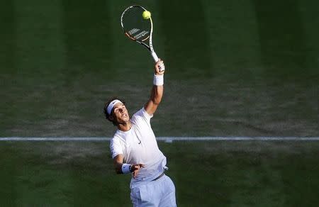 Rafael Nadal of Spain stretches for a shot during his match against Dustin Brown of Germany at the Wimbledon Tennis Championships in London, July 2, 2015. REUTERS/Suzanne Plunkett