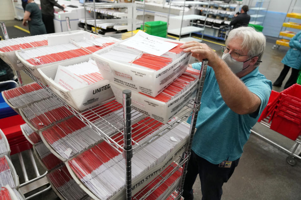 An election worker sorts mail-in ballots at the Multnomah County Duniway-Lovejoy Elections Building Monday, Nov. 2, 2020, in Portland, Ore. (AP Photo/Marcio Jose Sanchez)