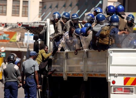 Riot police detain suspected opposition Movement for Democratic Change (MDC) supporters during clashes after police banned planned protests over austerity and rising living costs called by the opposition Movement for Democratic Change (MDC) party in Harare