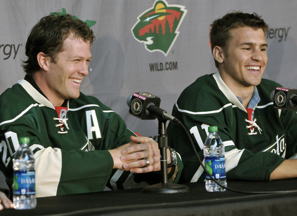FILE - In this July 9, 2012, file photo, Minnesota Wild NHL hockey players Ryan Suter, left, and Zach Parise are introduced during a news conference in St. Paul, Minn. After signing with Minnesota together, Zach Parise and Ryan Suter are being bought out together. The Wild announced Tuesday, July 13, 2021, that the team is buying out the final four years of each player's contract, a stunning move early in the NHL offseason. (AP Photo/Jim Mone, File)