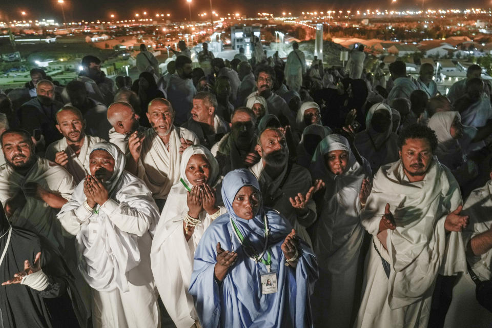 Muslim pilgrims pray on the rocky hill known as the Mountain of Mercy, on the Plain of Arafat, during the annual Hajj pilgrimage, near the holy city of Mecca, Saudi Arabia, Tuesday, June 27, 2023. Muslim pilgrims in Mecca circled the Kaaba, Islam's holiest site, and then converged on a vast tent camp in the nearby desert, officially opening the annual Hajj pilgrimage on Monday, returning to its full capacity for the first time since the coronavirus pandemic. (AP Photo/Amr Nabil)