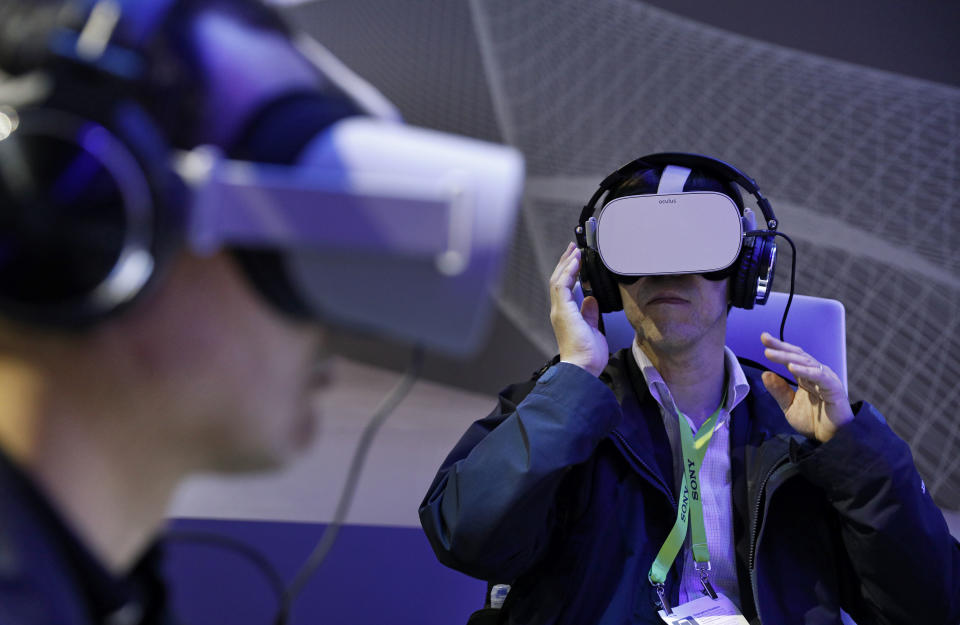 People use Oculus VR headsets at the Panasonic booth at CES International, Tuesday, Jan. 8, 2019, in Las Vegas. (AP Photo/John Locher)