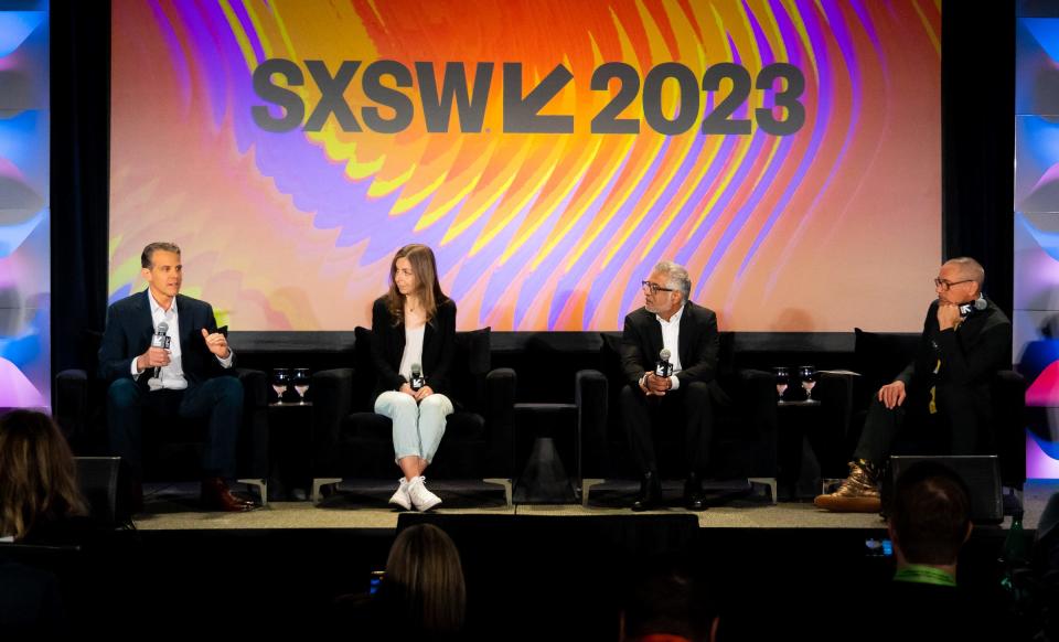 Robert Downey Jr., right, listens to Eric O'Neill, left, from SPYEX, speak during a South by Southwest panel on March 11 at the Austin Convention Center. The session also included author Maria Konnikova, center left, and Aura CEO Hari Ravichandran, center right.