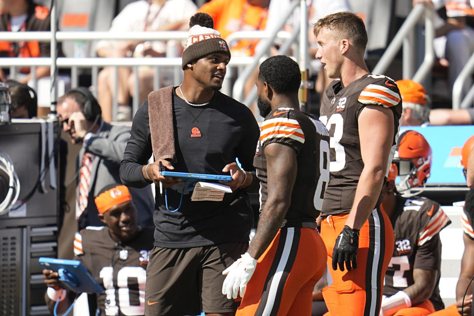 Cleveland Browns quarterback Deshaun Watson, left, stands on the sideline during the first half of an NFL football game against the Baltimore Ravens, Sunday, Oct. 1, 2023, in Cleveland. (AP Photo/Sue Ogrocki)