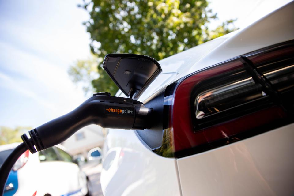 Jeff and Jill Raywood's Tesla Model 3 charges in their driveway Thursday, Sept. 30, in Holland.