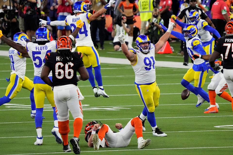 Los Angeles Rams nose tackle Greg Gaines (91) celebrates the tackle of Cincinnati Bengals quarterback Joe Burrow (9) during the second half of the NFL Super Bowl 56 football game Sunday, Feb. 13, 2022, in Inglewood, Calif.