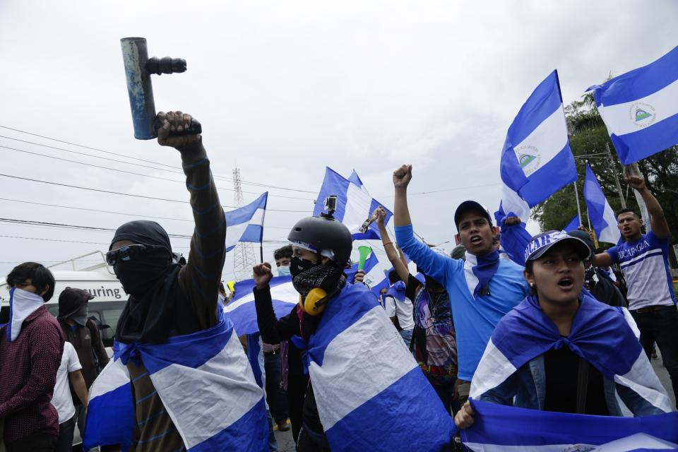 Demonstrators protest outside the Jesuit run Universidad Centroamericana, UCA, demanding the university's allocation of its share of 6% of the national budget, in Managua, Nicaragua, Thursday, Aug. 2, 2018. Universities in Nicaragua are closed since mid-April as students are demanding the resignation of President Daniel Ortega and the release of all political prisoners. (AP Photo/Arnulfo Franco)