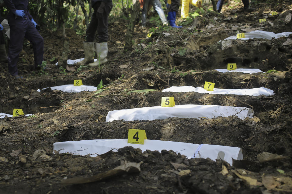 Human remains after being numbered by forensics workers at a mass grave in the village of Ndoma, near Beni in North Kivu, Congo Saturday, May 6, 2023. The remains of at least 20 people were found buried in a mass grave in a cacao plantation in Ndoma village in Congo's North Kivu province, according to local authorities and a military spokesperson. The remains of at least 20 people were found buried in a mass grave in an area used to cultivate cacao in Ndoma village in Congo's North Kivu province this weekend, according to local authorities and a military spokesperson. (AP Photo)