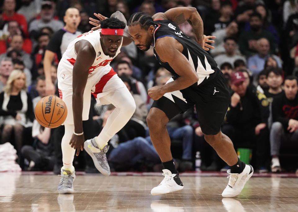 Los Angeles Clippers forward Kawhi Leonard, right, steals the ball from Toronto Raptors forward Pascal Siakam during the first half of an NBA basketball game Tuesday, Dec. 27, 2022, in Toronto. (Frank Gunn/The Canadian Press via AP)