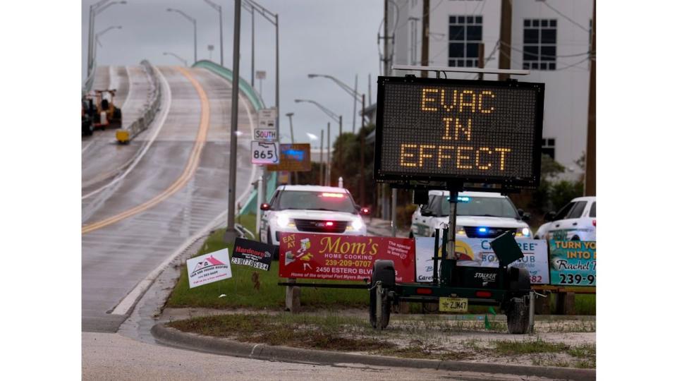 A sign indicates that an evacuation order is in effect for the beach area before Hurricane Milton's arrival on October 08, 2024, in Fort Myers, Florida. People are preparing for the storm, which could be a Cat 3 when it makes landfall on Wednesday evening