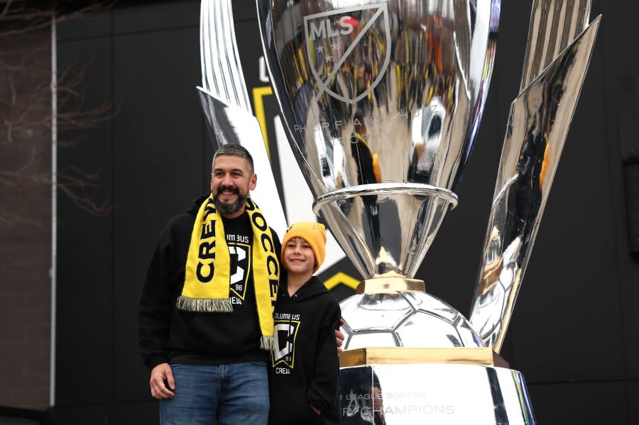 COLUMBUS, OHIO – DECEMBER 09: Fans pose in front of a replica of the Philip F. Anschutz Trophy outside the stadium before the 2023 MLS Cup at Lower.com Field on December 09, 2023 in Columbus, Ohio. (Photo by Patrick Smith/Getty Images)
