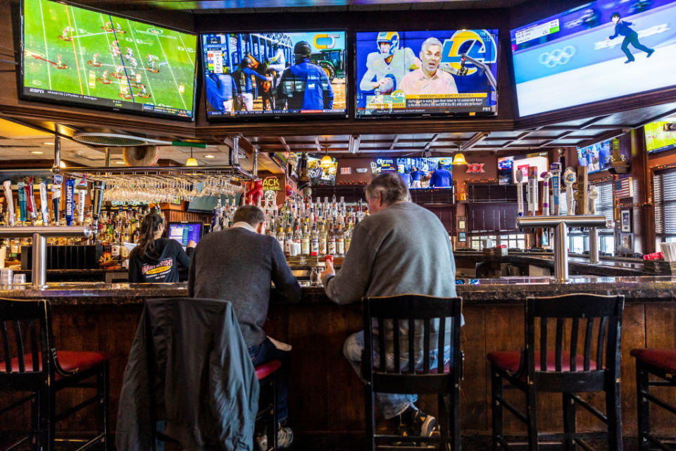 Patrons watching TV at a sports bar.