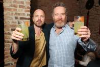 <p><em>Breaking Bad</em> stars Aaron Paul and Bryan Cranston raise a glass or two using their mescal brand Dos Hombres at Tao Chicago on May 21.</p>