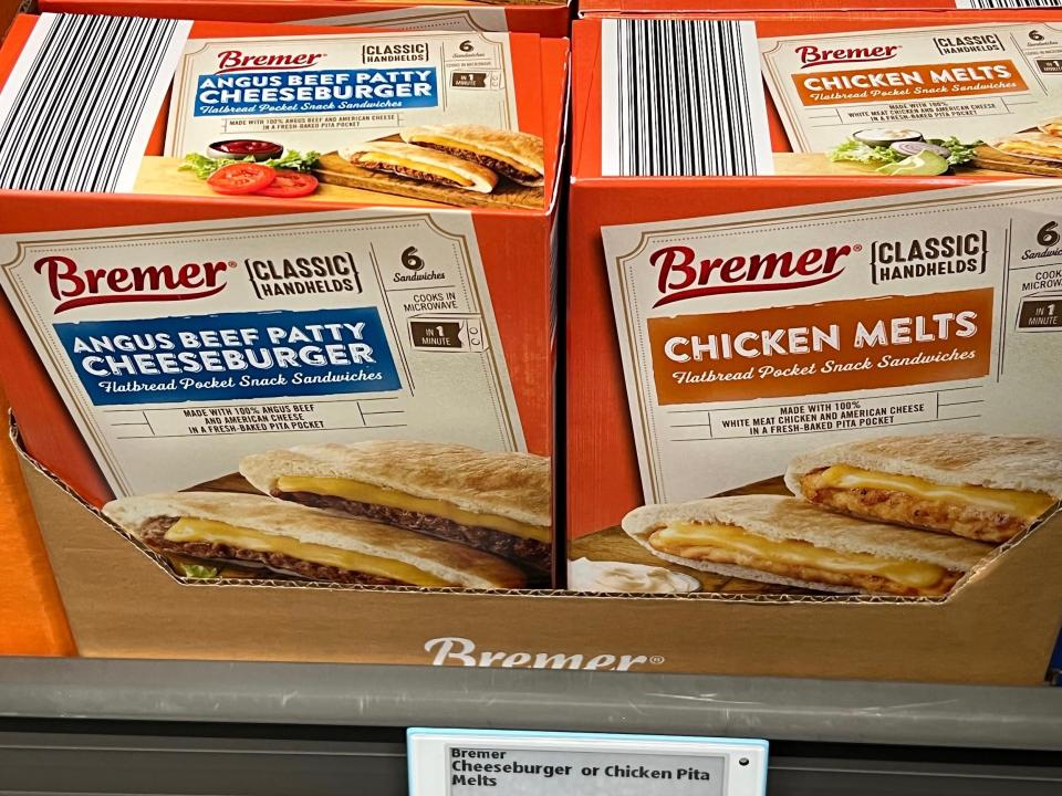 Red and tan boxes of Bremer chicken melts and Angus beef patty cheeseburgers