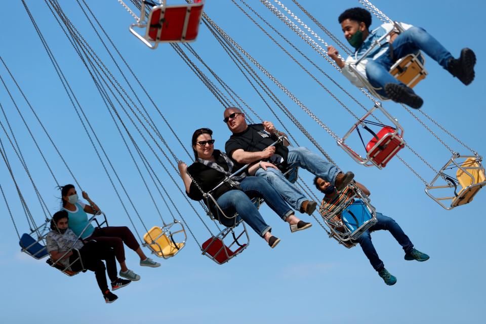 People enjoy their time in a wave swinger Friday, May 14, 2021 at Chicago's Navy Pier.