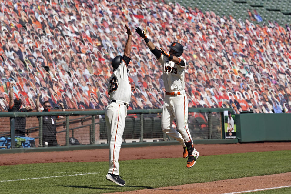 San Francisco Giants' Mauricio Dubon, right, is greeted by third base coach Ron Wotus after hitting a home run off San Diego Padres starting pitcher Adrian Morejon in the second inning of a baseball game Sunday, Sept. 27, 2020, in San Francisco. (AP Photo/Eric Risberg)