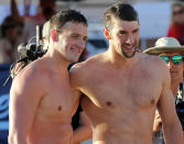 Michael Phelps, right, and Ryan Lochte pose for a photo after competing in the 100-meter butterfly final during the Arena Grand Prix swim meet, Thursday, April 24, 2014, in Mesa, Ariz. It is Phelps' first competitive event after a nearly two-year retirement. Lochte finished first and Phelps finished second. (AP Photo/Matt York)