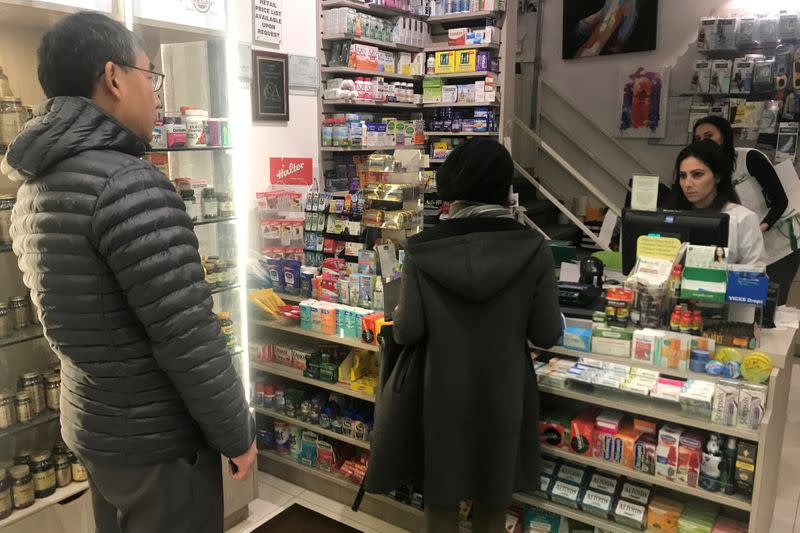 People line up at a pharmacy to purchase N95 face masks in advance of the potential coronavirus outbreak in the Manhattan borough of New York City