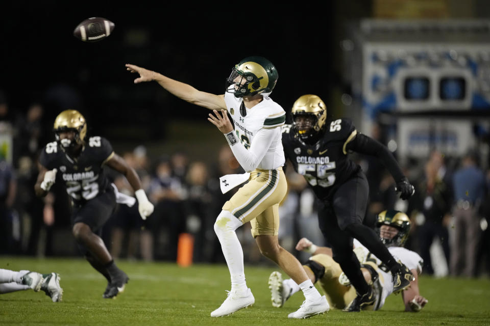 Colorado State quarterback Brayden Fowler-Nicolosi, center, throws a pass as Colorado linebacker Marvin Ham II (25) and defensive lineman Leonard Payne Jr. (55) pursue in the first half of an NCAA college football game Saturday, Sept. 16, 2023, in Boulder, Colo. (AP Photo/David Zalubowski)