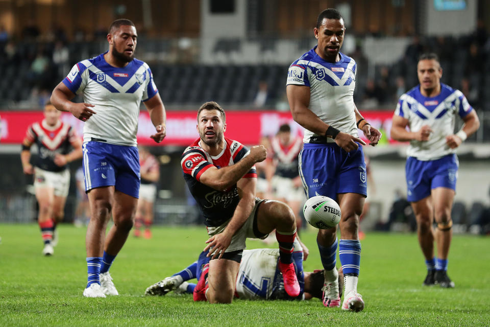 James Tedesco celebrates a try by throwing the ball.