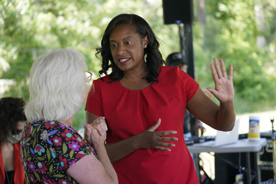 Democratic gubernatorial candidate, former Del. Jennifer Carroll Foy, right, talks with a greets supporter during a rally in Hampton, Va., Tuesday, June 1, 2021. Carroll Foy faces four other Democrats in the primary June 8. (AP Photo/Steve Helber)