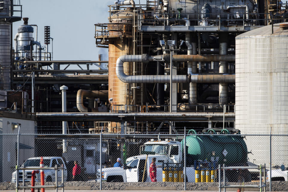 Workers stand in a lot at a LyondellBasell facility in La Porte, Texas Tuesday, July 27, 2021. An explosion Tuesday evening killed two people at the facility and left several others injured. (Mark Mulligan/Houston Chronicle via AP)