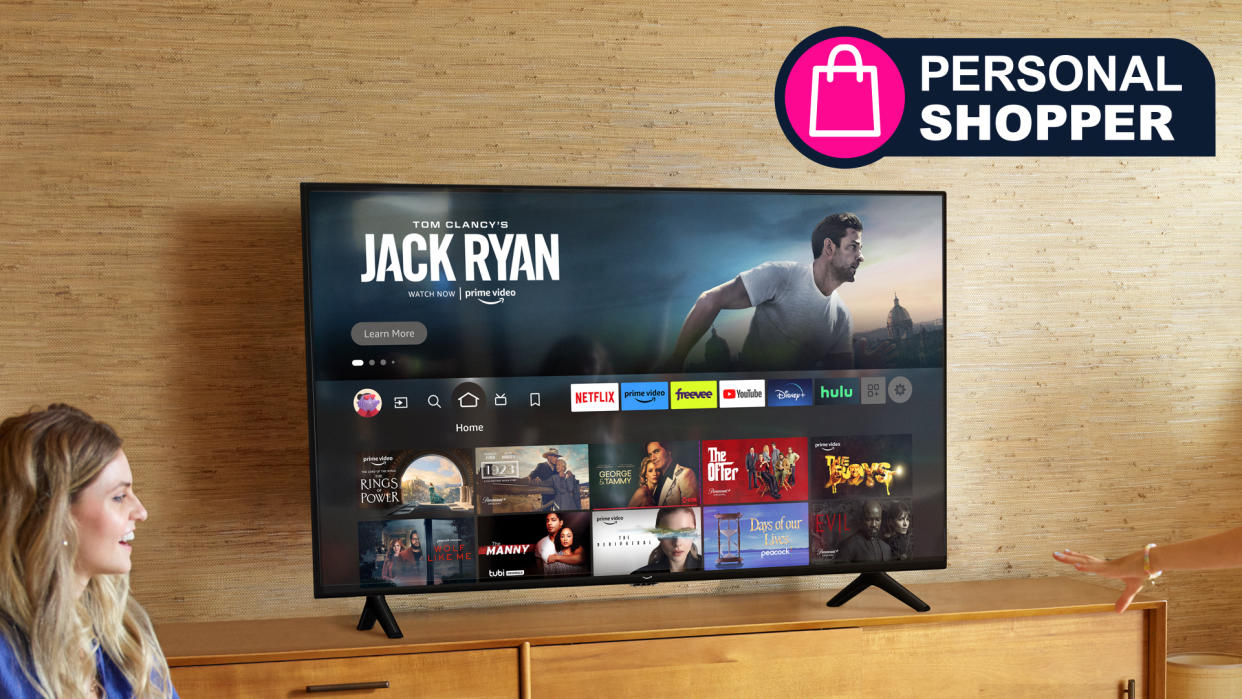  An Amazon Fire TV on a TV surface, with a sign saying 'Personal Shopper' 