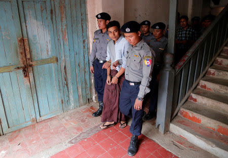 Detained Reuters journalist Kyaw Soe Oo is escorted by police after a court hearing in Yangon, Myanmar February 28, 2018. REUTERS/Stringer