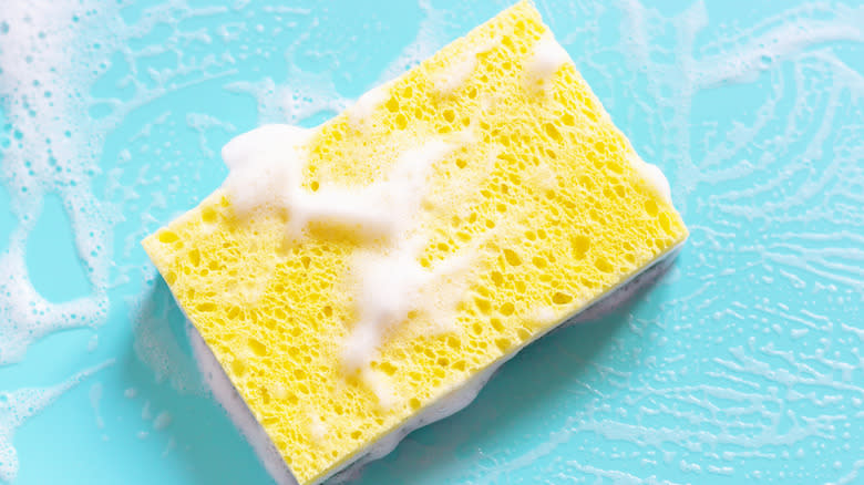 Yellow sponge with soap foam