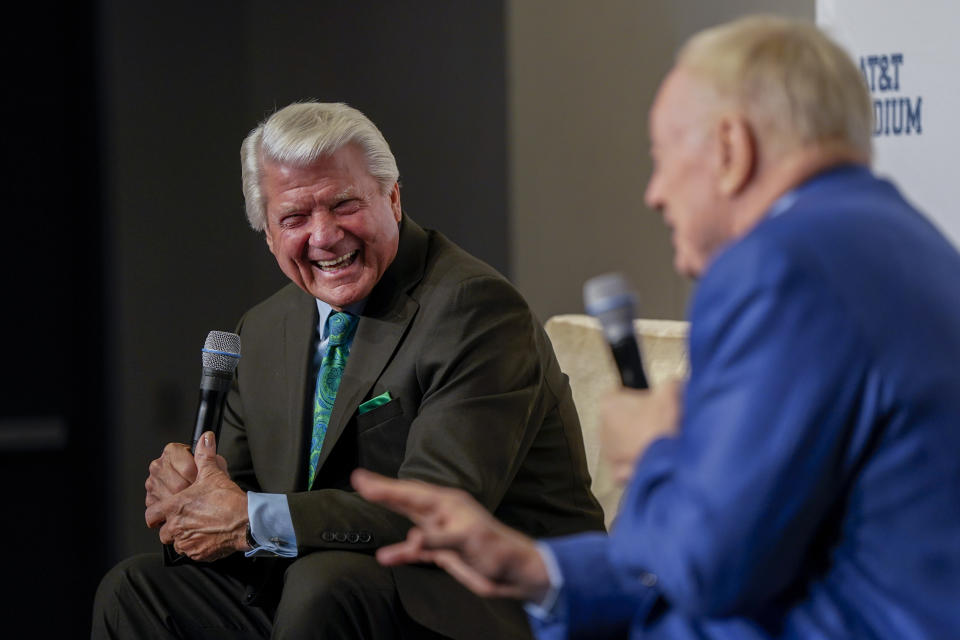 Pro Football Hall of Fame coach Jimmy Johnson, left, looks on during a news conference as Dallas Cowboys owner Jerry Jones speaks prior to an NFL football game between the Cowboys and the Detroit Lions, Saturday, Dec. 30, 2023, in Arlington, Texas. Johnson will be inducted into the team's ring of honor during a halftime ceremony. (AP Photo/Sam Hodde)