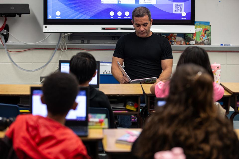 Yoan Gonzalez reads "Little Red Riding Hood" in Spanish to a third grade class for Hispanic Heritage Month at Blanche Moore Elementary School on Thursday, Sept. 28, 2023, in Corpus Christi, Texas.
