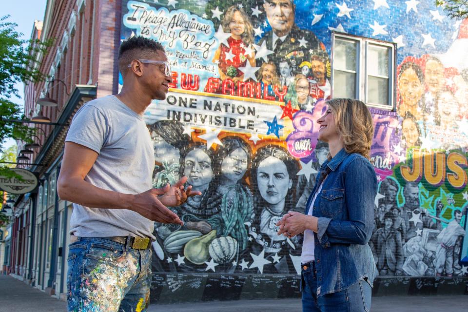 Rochester-based artist Shawn Dunwoody and TV travel host Samantha Brown in front of one of Dunwoody's community murals in Mount Morris.