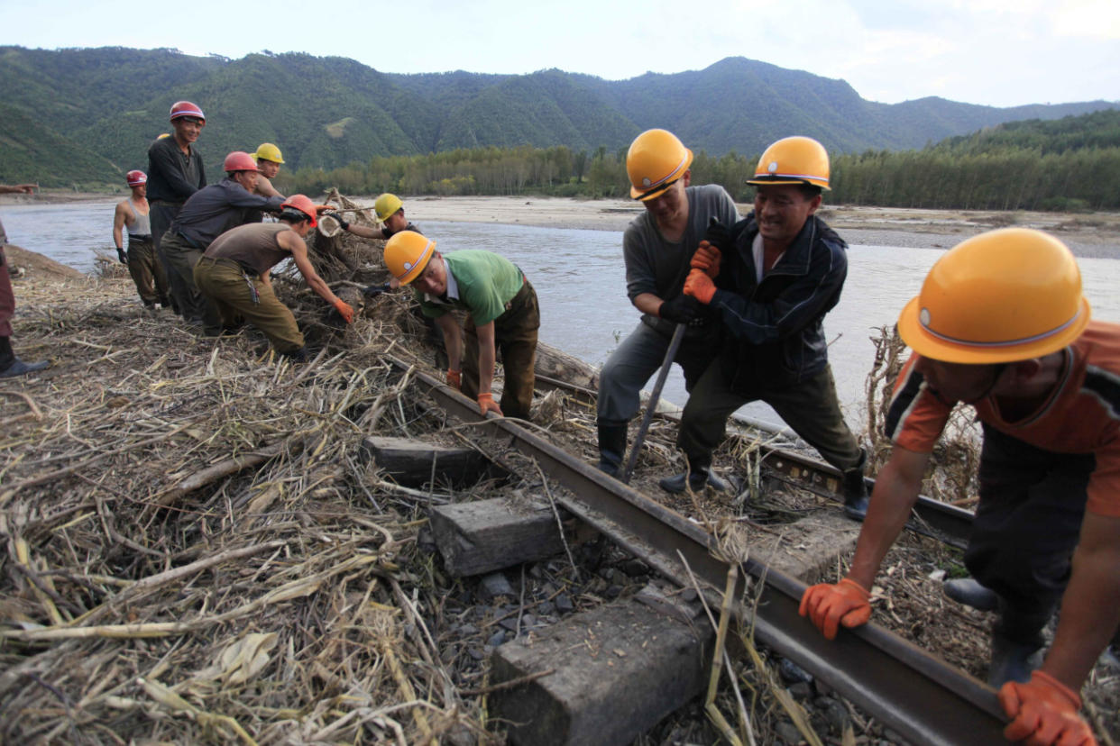 Workers repair the flood-damaged train track between Sinjon and Kanphyong train stations in North Hamgyong Province, North Korea, Friday, Sept. 16, 2016. (AP Photo/Kim Kwang Hyon)