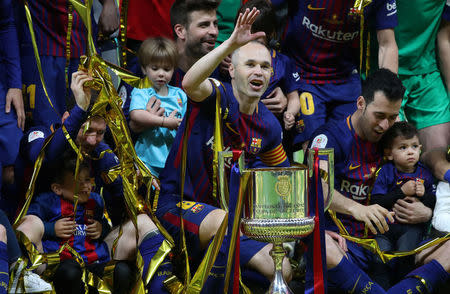 Soccer Football - Spanish King's Cup Final - FC Barcelona v Sevilla - Wanda Metropolitano, Madrid, Spain - April 21, 2018 Barcelona's Andres Iniesta, Lionel Messi, Gerard Pique and Sergio Busquets celebrate with the trophy after winning the final REUTERS/Susana Vera