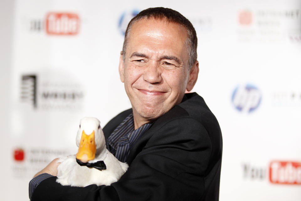 Comedian Gilbert Gottfried arrives with a duck at the Webby Awards in New York June 14, 2010. REUTERS/Lucas Jackson (UNITED STATES - Tags: ENTERTAINMENT ANIMALS)