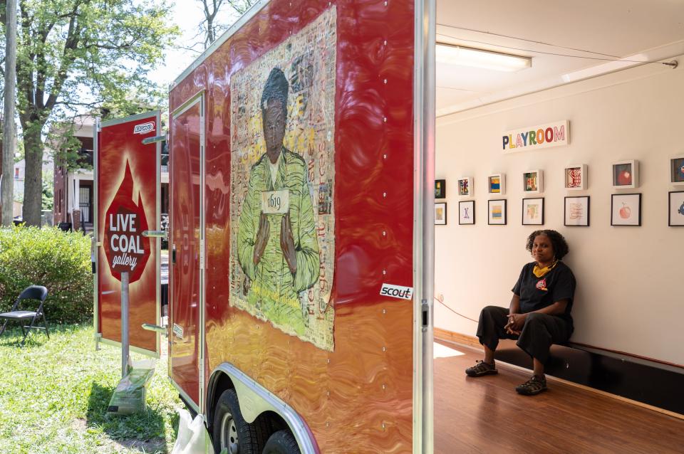 Yvette Rock of Detroit sits in the Live Coal Gallery mobile art gallery at her home in Detroit on August 7, 2020. The new gallery "Lego Mosaics" includes work where her sons replicated submitted pictures using Legos that are on display.