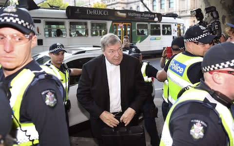 Cardinal George Pell arrives in court in Melbourne amid a heavy police presence - Credit: AFP