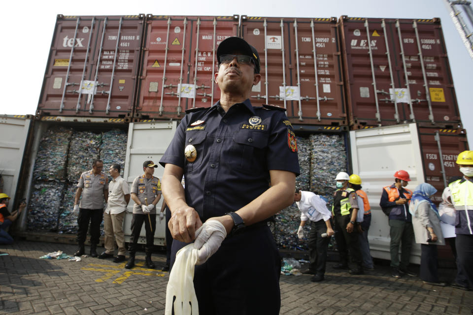 Director General of Indonesian Customs and Excise Heru Pambudi speaks to the press near containers full of plastic waste at Tanjung Priok port in Jakarta, Indonesia Wednesday, Sept. 18, 2019. Indonesia is sending hundreds of containers of waste back to Western nations after finding they were contaminated with used plastic and hazardous materials. (AP Photo/Achmad Ibrahim)