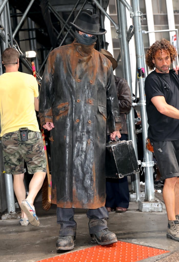 Christian Bale in his trench coat and face covering filming “The Bride.” GC Images