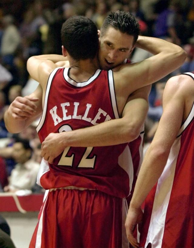 Wisconsin's Mike Kelley (22) hugs teammate Andy Kowske after Wisconsin beat LSU 61-48 to win the semi-final game in the NCAA West Regional Thursday, March 23, 2000, in Albuquerque, N.M.